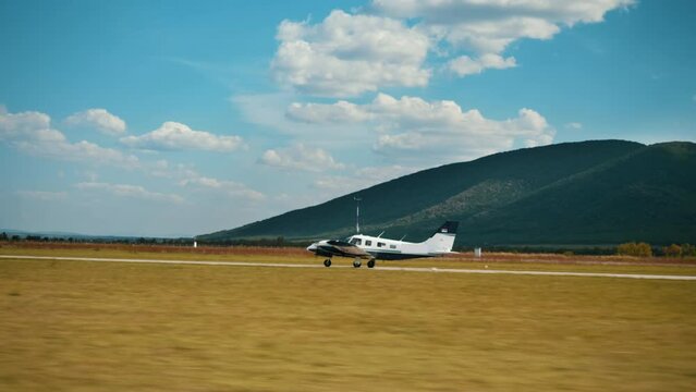 Side view shot of an airplane moving along the runway is ready to take-off
