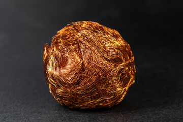Many lacquered copper wires from the disassembly of a transformer coil in the foreground. Scrap...