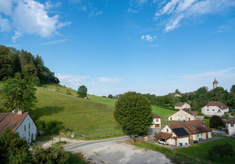 countryside and rolling hills and village in french jura