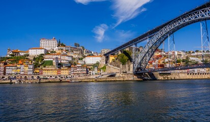 Obraz premium Stunning view of a bridge stretching over a river in the city of Porto, Portugal