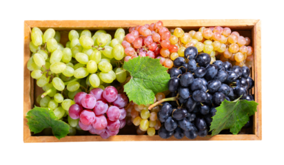 mix of fresh colorful grapes with leaves in a wooden box isolated on transparent background, top view