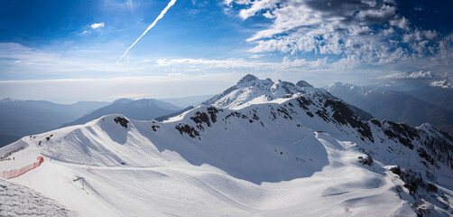 Ski slopes at a popular year-round tourist ski resort of Krasnaya Polyana, Sochi. Snow-capped...