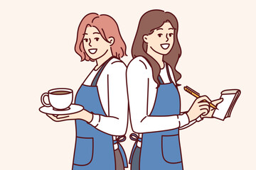 Happy woman waitresses smiling holding coffee and notepad for writing restaurant customer orders. Two waitresses in aprons work in hospitality industry helping cafe customers to have good time