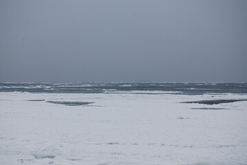Black sea, winter, melancholy.There is a ship in the road stead in the fog.