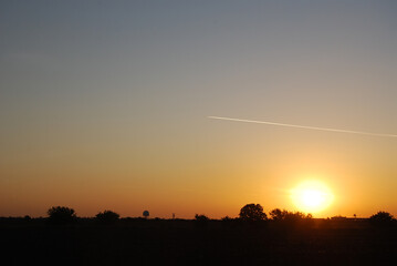 Sky, sun, evening and air plane with contrail.