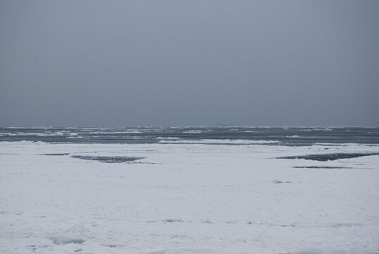 Black sea, winter, melancholy.There is a ship in the road stead in the fog.