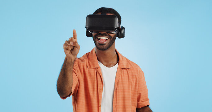 Man, virtual reality and glasses in studio with hand, click and swipe with smile for metaverse by blue background. Person, AR vision and futuristic game with 3D user experience, cyber ui and esports