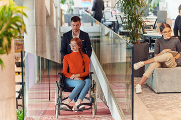 A company director assists his business colleague in a wheelchair, helping her navigate to their startup office, where they work alongside their diverse team of colleagues, emphasizing inclusivity and