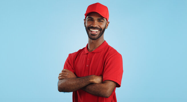 Delivery man, arms crossed in portrait and e commerce, distribution with supplier and service on blue background. Professional, supply chain and logistics worker for shipping and courier in studio