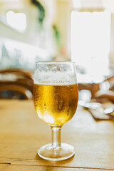 a cold beer on top of a bar table