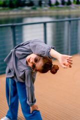 Naklejka premium young street hip hop dancer in sportswear doing warm up before dance rehearsal hobby active lifestyle