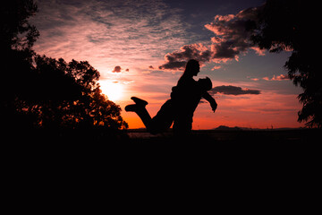silhouette of a couple in love at sunset against the backdrop of nature. there is a place