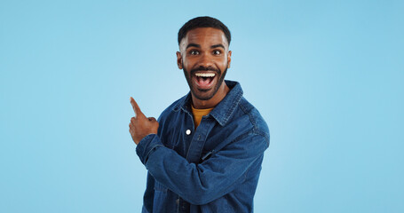 Advertising studio smile, man and pointing at ads commercial, retail information or discount announcement. Sales info, mockup space and portrait person show service, deal or news on blue background