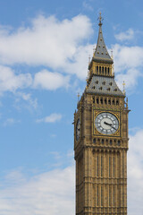Closeup of iconic building in London, Big Ben on a sunny day with some clouds