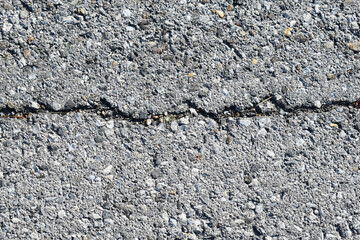 Old grey cracked rough asphalt surface texture
