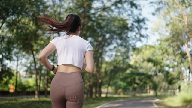 4k resolution slow motion Asian female woman doing workout stretching, jogging and running on summer at a city park,health care and sportive concept.