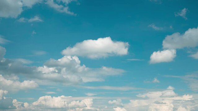 Fluffy white clouds timelapse. Clouds flying along blue sky time lapse