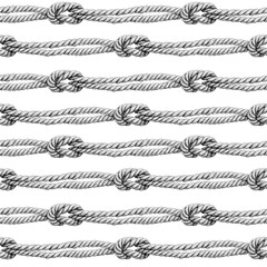 Obraz premium Seamless pattern of rope cords with knots. Hand drawn illustration. Hand painted black elements on white background. 