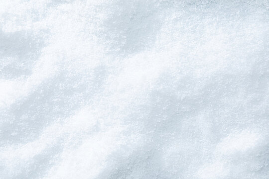 Snow texture on a sunny day. Sparkling shining Christmas background