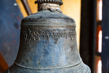 Bronze bell with Bhutanese writing inside of a Monks school monastery, Mongar, Bhutan, Asia