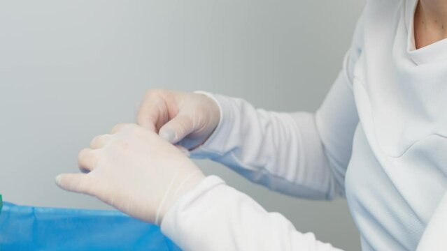 Doctor cosmetologist draws blood plasma into a syringe for the plasmolifting procedure, hands in gloves closeup. PRP therapy treatment in beauty clinic. Cure of problem skin.