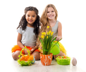 two beautiful little girls playing fluffy chicken toys on the floor isolated on white background