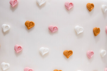 small colored sugar hearts on a white background
