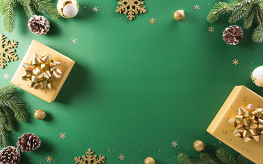 Christmas and new year background concept. Top view of Christmas gift box, christmas ball and snowflake on green background.