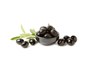 Tasty black olives isolated on white background. Olive and olive tree branches on a white table. Delicacy.