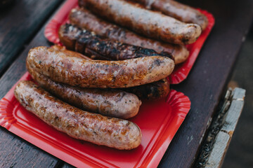 Delicious grilled sausage on a barbecue. Picnic menu.