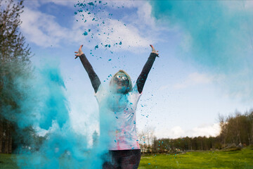 Portrait of happy European woman celebrating Holi with powder colors or gulal.