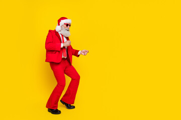 Full length photo of cool attractive santa dressed red suit tie having fun dancing discotheque empty space isolated yellow color background