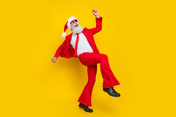 Fototapeta na wymiar Full length photo of cheerful positive clauswear red tux costume having fun dancing disco isolated yellow color background