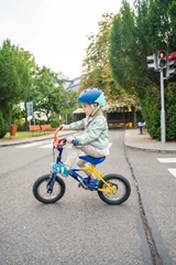 Zelfklevend Fotobehang Three year old girl to ride public bike on one of traffic playground in Prague, Czech republic © dtatiana
