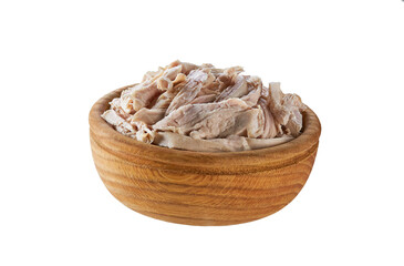 Boiled shredded chicken meat in a wooden bowl isolated on a white background.