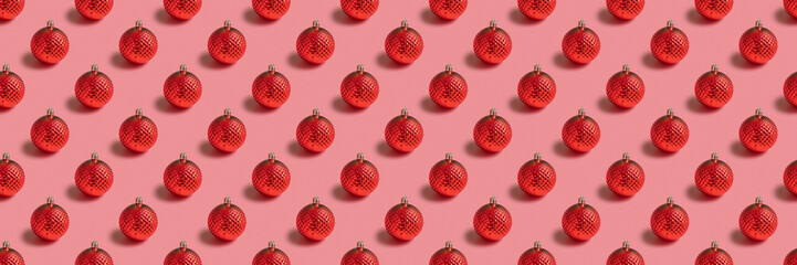 Seamless pattern with Christmas bauble on pink background. Holiday banner.