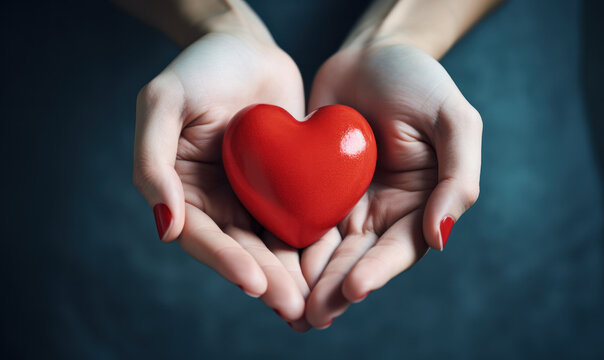 Close-up of red heart holding in hands