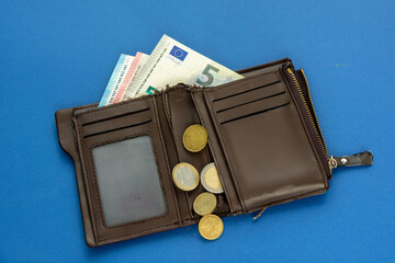 Old wallet and small euro banknotes and coins. concept poverty inflation and consumer financial crisis in Europe
