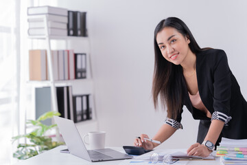 Business Documents concept: Employee woman hands working in Stacks paper files for searching and checking unfinished.