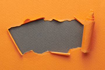 Frame of ripped paper with torn edges. Window for text with copy space orange gray colors, shreds...