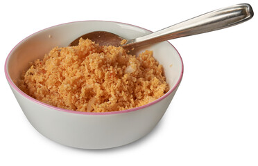 coconut sambol or pol sambol in white bowl with a spoon, popular traditional and delicious condiment made from freshly grated coconut mixed with chili flakes, isolated on white background