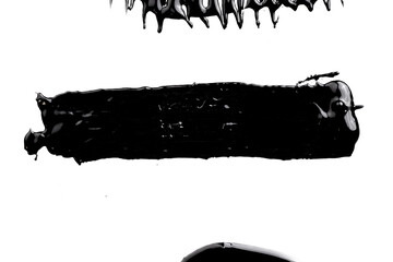 Acrylic paint blot, chaotic brushstroke, spot flowing on white paper background. Creative black color backdrop, fluid art.