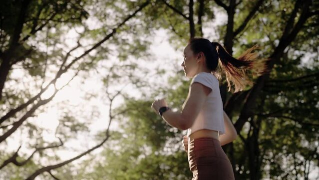 4k resolution slow motion Asian female woman doing workout stretching, jogging and running on summer at a city park,health care and sportive concept.