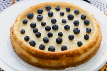 milk tart with fresh blueberries on display at a bakery