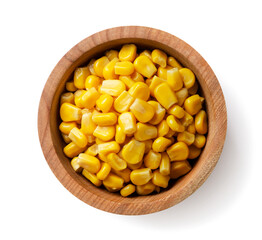 Canned corn in a wooden plate on a white background. Top view