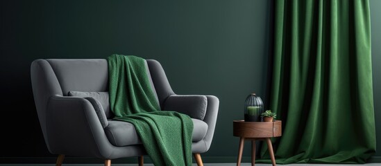 Green blanket on gray sofa in bright living room with empty poster and armchair With copyspace for text