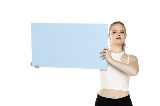 Banner Of Young Serious Blonde Woman Feeling Happiness And Holding Blue Empty White Canvas Frame For Text Or Advertising Isolated On White Background