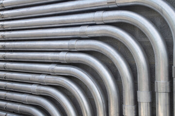 Steel conduit lines run along a block wall - obrazy, fototapety, plakaty