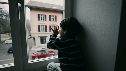 Sad Depressed Little Boy Staring at Street from Second Floor, Wanting to Go Outside, Bored Child...