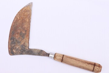 old sickle with wooden handle, isolated on white background